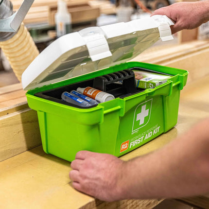 A person opening the FastAid R2 workplace first aid kit for emergency use