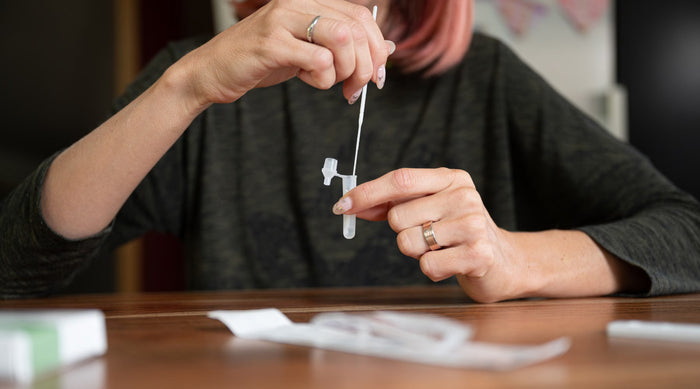 Woman doing self test for COVID, RSV and influenza at home