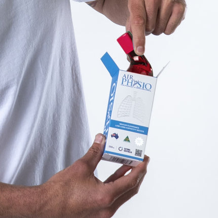 AirPhysio Low Lung Capacity red device being unboxed, showing packaging and handheld breathing therapy tool