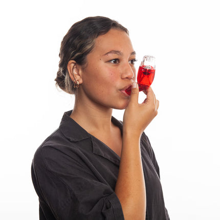 Woman showing how to use the Better Breathing Sports device for airway clearance and lung conditioning