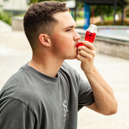 Athlete using the Better Breathing Sports handheld breathing trainer to support lung expansion and mucus clearance