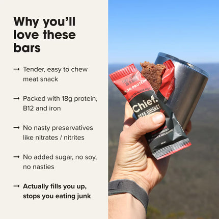 Hand holding a Chief Beef Brisket Cayenne Chilli protein bar with a scenic background