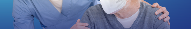 Healthcare worker and older man wearing AMD P2 face masks