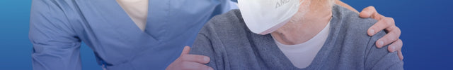 Aged care worker and senior wearing AMD P2 face masks with boxes displayed below on a blue background
