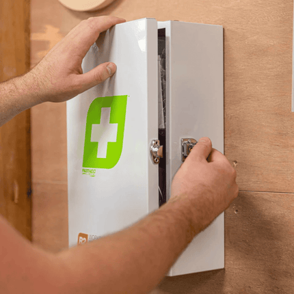 Worker opening FastAid R2 Workplace Response Metal Cabinet First Aid Kit 