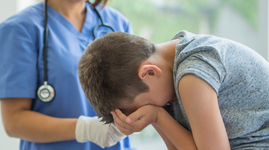 Doctor checking up on little boy with influenza