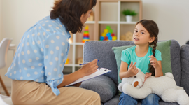 Teacher evaluating reading capability of student