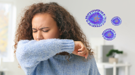 Girl sneezing into arm to avoid spreading hMPV
