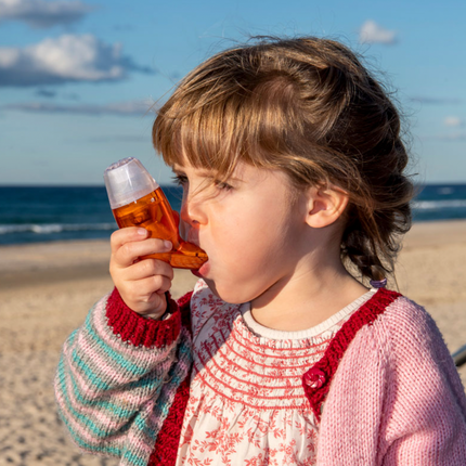 A child using AirPhysio to clear mucus and breathe easier.